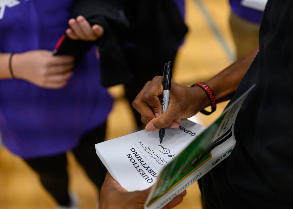 Kenny Glenn signing a copy of Question Everything