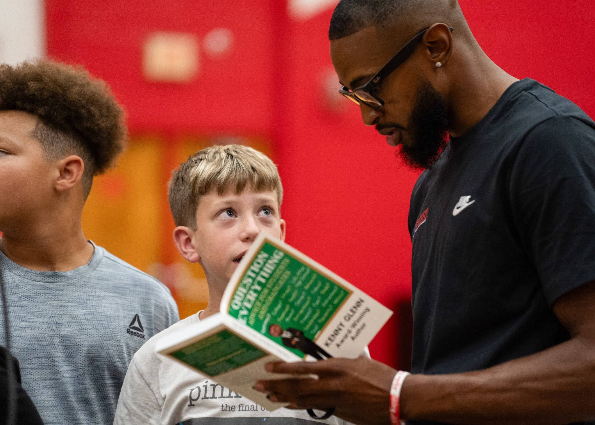 Kenny Glenn discussing Question Everything with a student