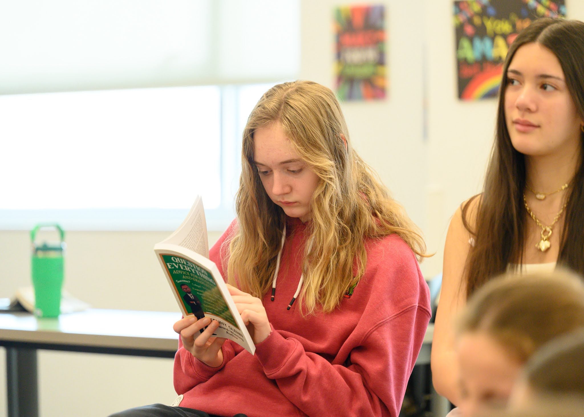 Student reading Question Everything in class